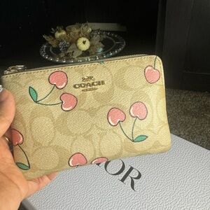 Coach peach wristlet . It’s really gentle used inner is clean .